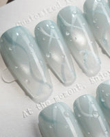 Still Water medium coffin nails with condensation-like beads on translucent green gel