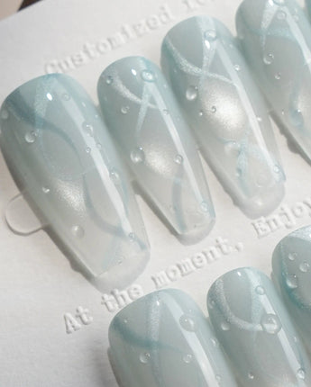 Still Water medium coffin nails with condensation-like beads on translucent green gel