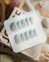 Still Water short square press-on nails with sheer mint-green jelly finish