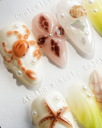 Sun Fossil ivory and lemon-yellow press-on nails with sun-baked shell accents