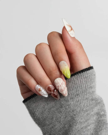 Sun Fossil warm beach press-on nails with sculpted sea charms and sandy tones