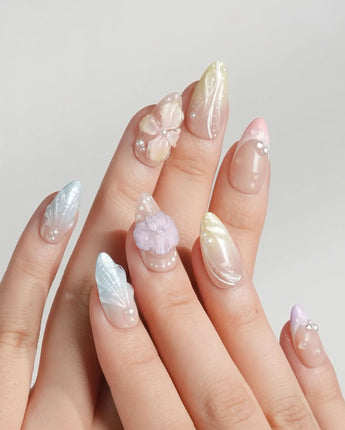 Sunbathing pastel island nails with macaron base, sheer chrome, and sculpted shells