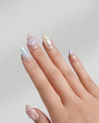 Sunbathing short almond nails with summer chrome glow and 3D flower accents