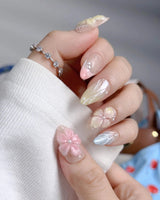 Sunbathing close-up of glossy pastel florals, shell details, and iridescent nude gel