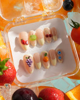 Sunny Mix medium almond press-on nails with creamy French tips and 3D mixed fruits