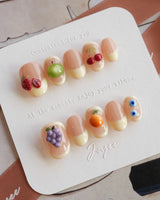 Sunny Mix medium almond nails with 3D fruit pieces and summer jelly shine