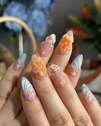 Sunset Shore close-up of orange 3D flowers, nude base, and shimmering shell texture