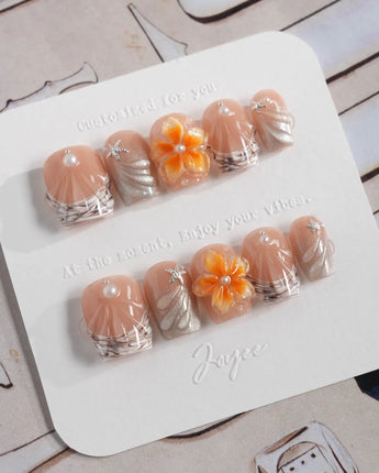 Sunset Shore extra short coffin nails with nude orange florals and coastal shell texture