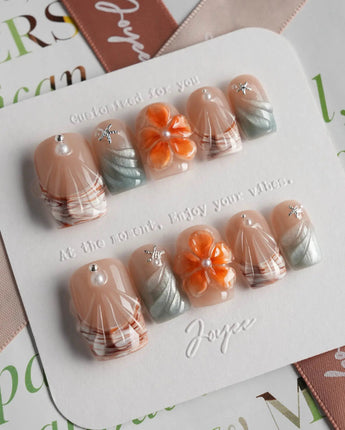 Sunset Shore short square nails with sculpted flowers, silver wave lines, and coral tones