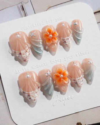 Sunset Shore short stiletto nails with coral sunset palette and sculpted shell details