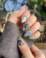 Mindbend illusion nails with star motif, warped patterns, and glossy retro color blocks
