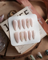 Sweet Nothings press-on nails in medium stiletto shape — Soft Nude Pink, Glitter Accents, Metal Heart & Silver Flowers.
