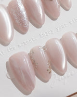 Sweet Nothings nail art close-up showing Soft Nude Pink, Glitter Accents, Metal Heart & Silver Flowers. details