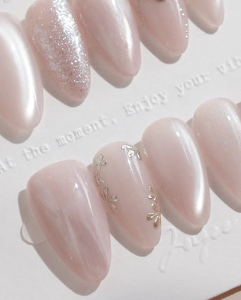 Sweet Nothings nail art close-up showing Soft Nude Pink, Glitter Accents, Metal Heart & Silver Flowers. details