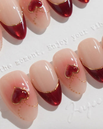 Sweet Venom nail art close-up showing Ruby Red French, gold Outlines, 3D Red Hearts & Shimmering Lines. details