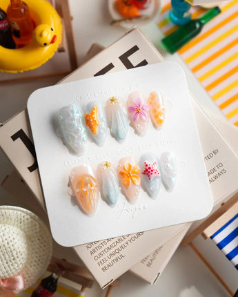 Tangerine Dream glossy coral press-on nails with pearls, starfish, and flower charms
