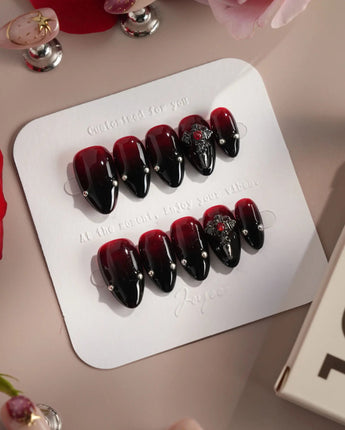 The Curse press-on nails — red to black gradient glossy chrome studs gothic cross charm handmade nail art by Joyee Nails