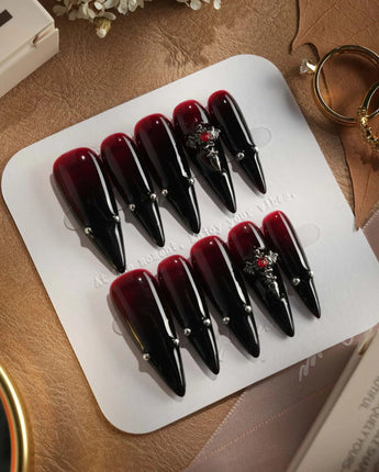 The Curse press-on nails — red to black gradient glossy chrome studs gothic cross charm handmade nail art by Joyee Nails