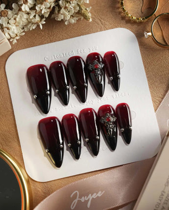 The Curse press-on nails — red to black gradient glossy chrome studs gothic cross charm handmade nail art by Joyee Nails