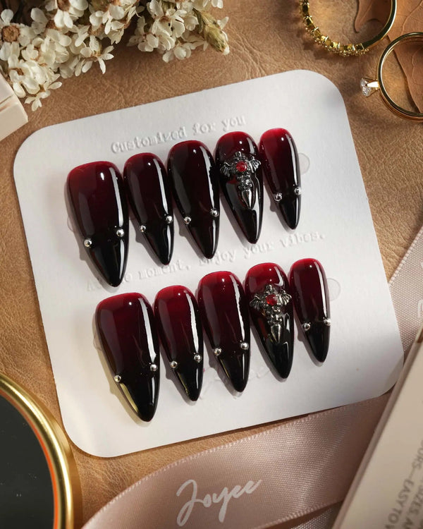 The Curse press-on nails — red to black gradient glossy chrome studs gothic cross charm handmade nail art by Joyee Nails