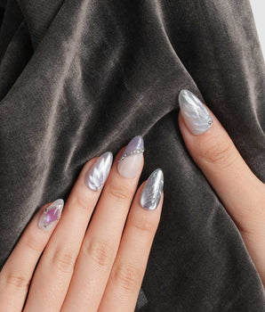 The Cygnus nail art close-up showing silver lilac cat eye feather chrome rhinestone cat eye effect details