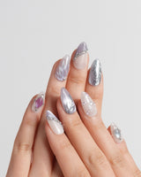 The Cygnus handmade press-on nails featuring silver lilac cat eye feather chrome rhinestone cat eye effect
