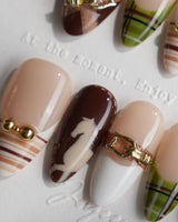 THE HEIR medium almond press-on nails with burgundy plaid, gold details and horsebit accents