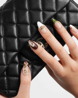 THE HEIR medium almond press-on nails with vintage plaid and metallic horsebit nail art