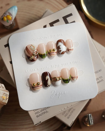 THE HEIR extra short oval press-on nails with burgundy plaid and horsebit-inspired nail art