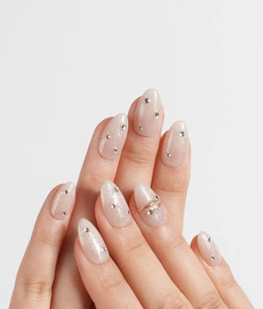 The Vow handmade press-on nails featuring Sheer Shimmering Glitter, Minimalist Silver Studs & Metallic Ring Accents.