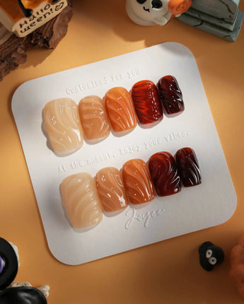 The Whole Fall nails with caramel amber gradient, glossy gel surface, and raised texture