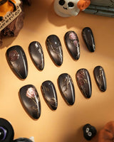 Thorned Spell nail art close-up showing black cat eye gold outline rose thorn design details