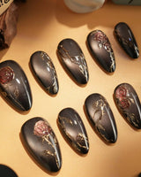 Thorned Spell handmade press-on nails featuring black cat eye gold outline rose thorn design