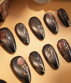 Thorned Spell handmade press-on nails featuring black cat eye gold outline rose thorn design