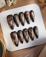 Thorned Spell press-on nails — black cat eye gold outline rose thorn design handmade nail art by Joyee Nails