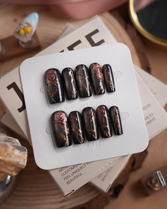 Thorned Spell press-on nails in medium square shape — black cat eye gold outline rose thorn design