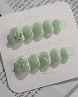 Thump Bunny_Mint press-on nails in extra short squoval shape — Sage Green, Velvet Cat Eye Bow.
