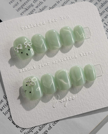 Thump Bunny_Mint press-on nails in extra short squoval shape — Sage Green, Velvet Cat Eye Bow.