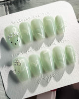 Thump Bunny_Mint press-on nails in short coffin shape — Sage Green, Velvet Cat Eye Bow.