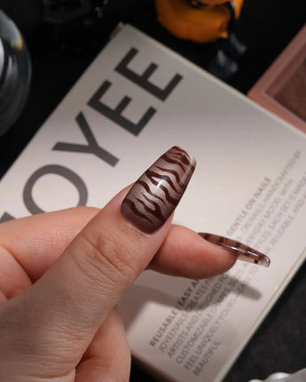 Tiger Eye handmade press-on nails in medium coffin shape by Joyee Nails
