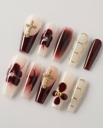 Tip Burgundy Nails in long coffin shape with deep red tips and ornate gold detailing