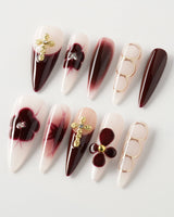 Tip Burgundy Nails in long stiletto shape with burgundy tips and gold floral cross accents