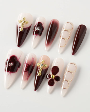 Tip Burgundy Nails in long stiletto shape with burgundy tips and gold floral cross accents