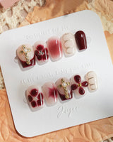 Tip Burgundy Nails in extra short coffin shape with burgundy tips and gold accent art