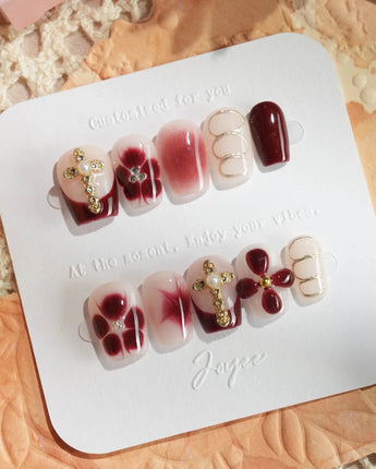 Tip Burgundy Nails in extra short coffin shape with burgundy tips and gold accent art
