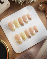 Tweed Light press-on nails with plaid French tips, nude gel base, and refined gold accents