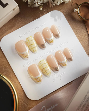 Tweed Light press-on nails with plaid French tips, nude gel base, and refined gold accents