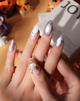 Twilight Pumpkin press on nails with chrome pumpkins, pastel ghosts and gold stars on lavender and copper cat eye - image 4
