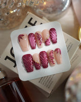 Velvet Flow medium coffin press-on nails with red cat-eye texture and butterfly wing details