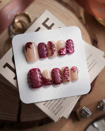 Velvet Flow short square press-on nails with berry red cat-eye texture and butterfly wings